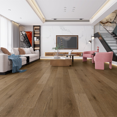 warm toned hardwood flooring in living room with white couch and pink accent chairs with maximalist decor